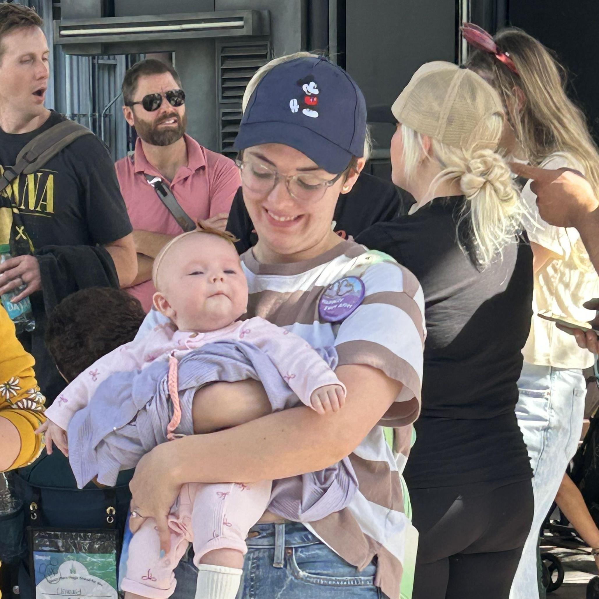 Emma getting sneezed on by her niece Hallie. Oct 2024.