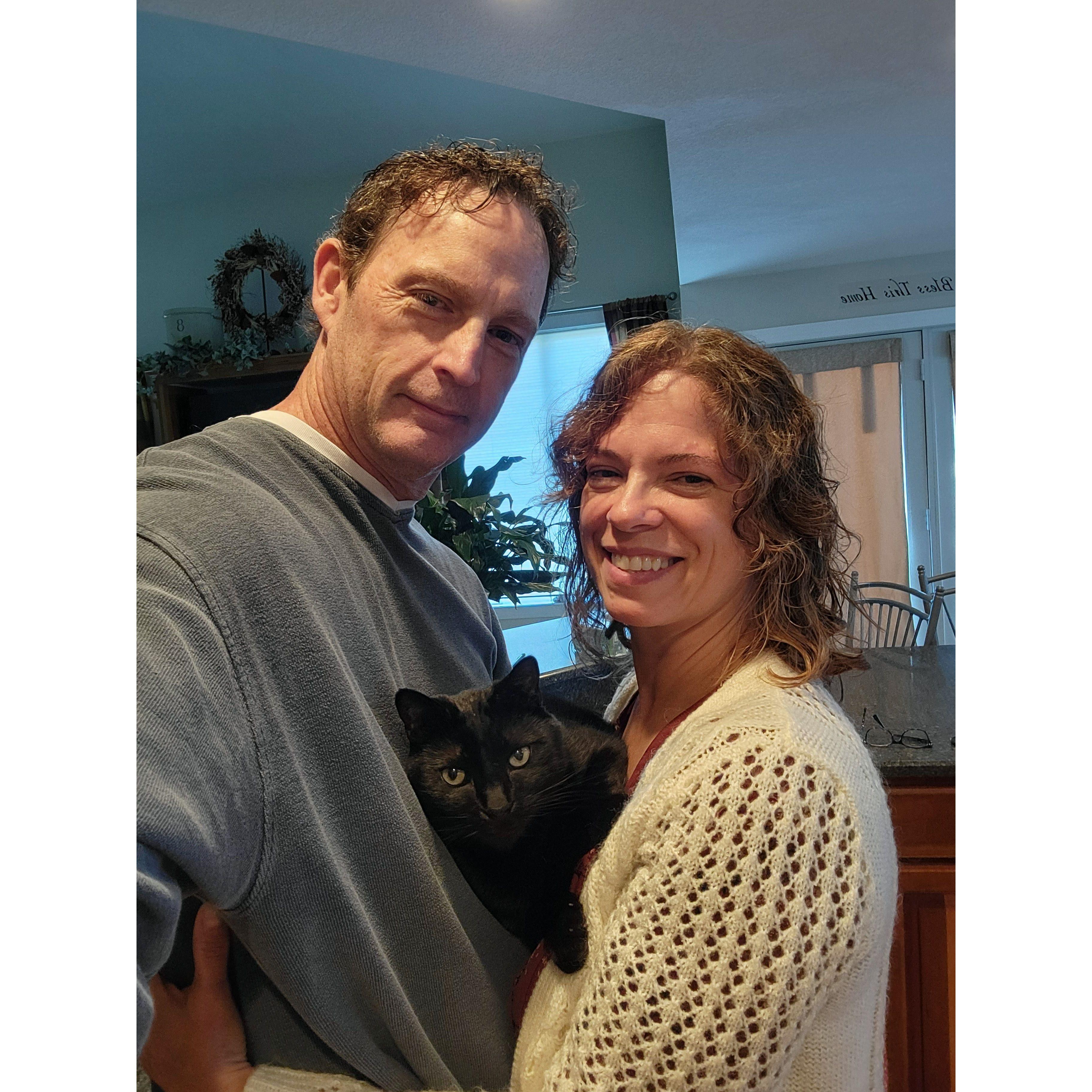 December 1, 2024. Jim and Pam visit in the kitchen and Mars decided he was tired of waiting for attention, so he found a gap and snuggled in. Jim and Pam have 3 cats! Pray they become friends!