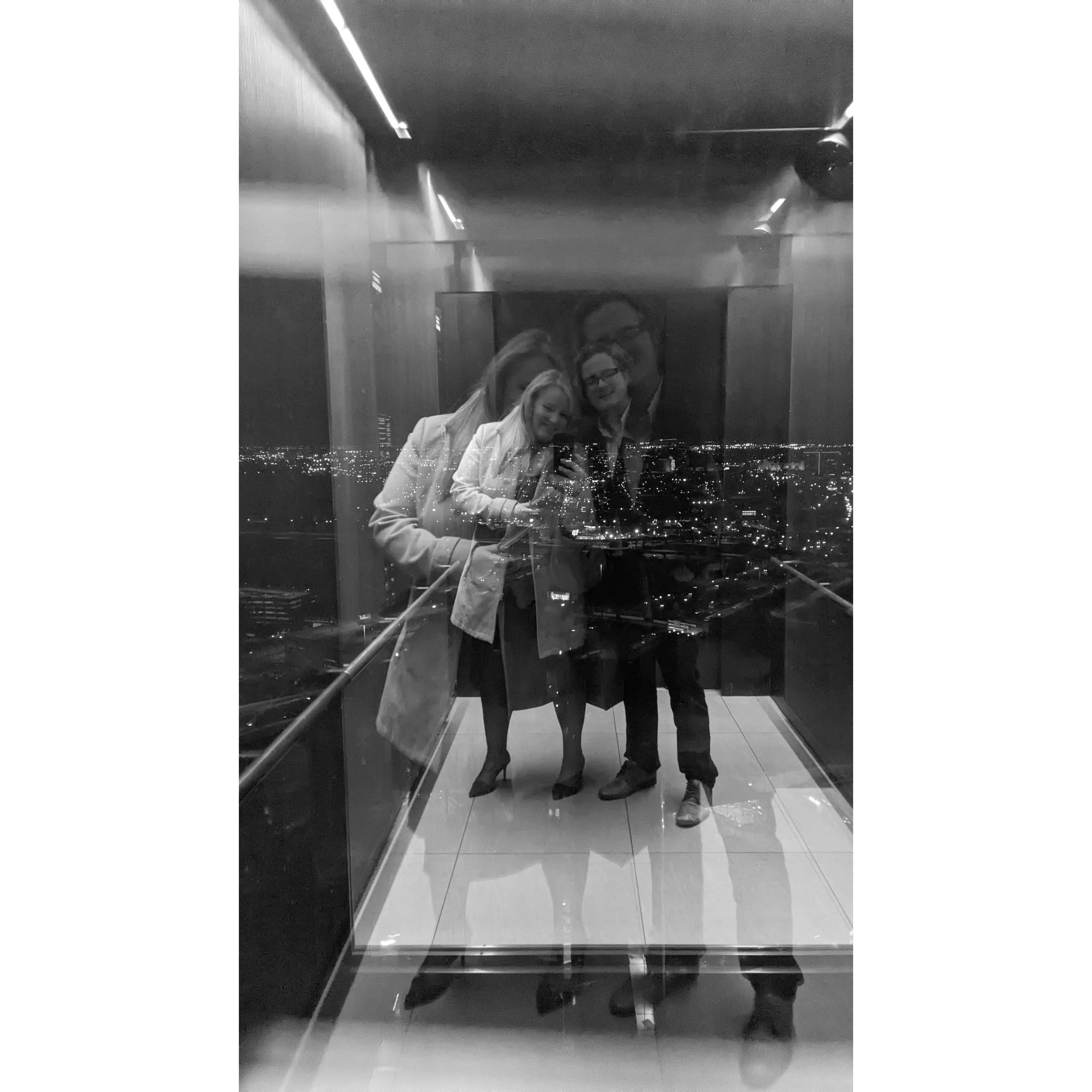Taking the elevator to Reunion Tower's Crown Block restaurant for Tim's birthday