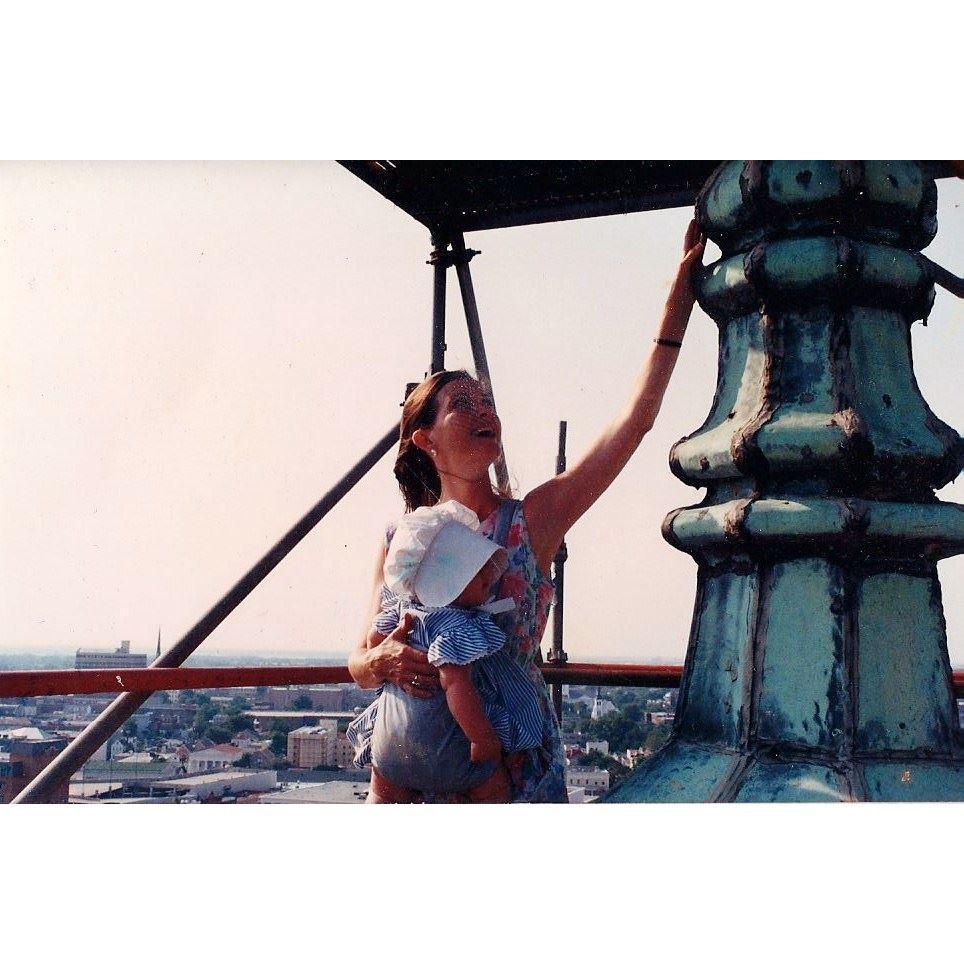 Laura taking baby Olivia up to touch the St. Philip's Steeple