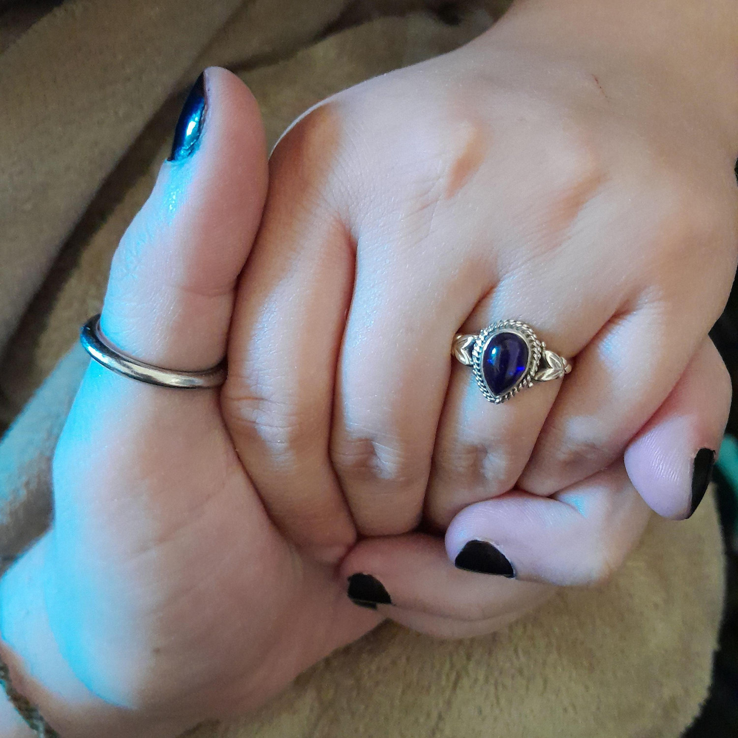 The picture we sent out to announce our engagement in November 2024. The stone is an amethyst from our favorite local crystal shop.