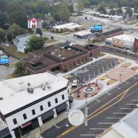 Overview of the wedding and reception locations. 
Parking lots have cars showing on them. 
Chapel has a chapel showing its location. 
Reception has a plate with silverware showing its location.