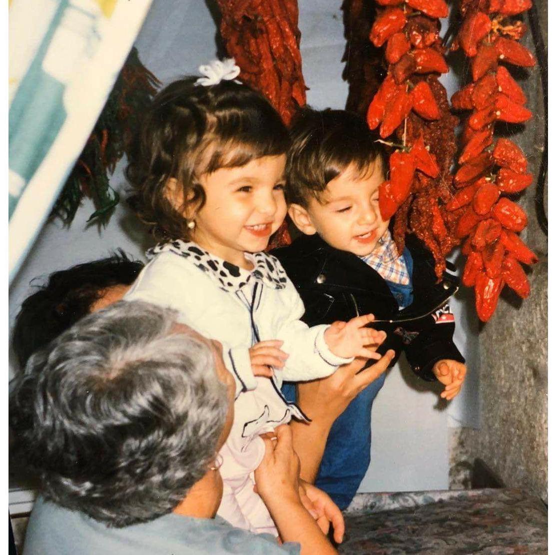 Saying hello to some hanging peppers with Nonna Donata