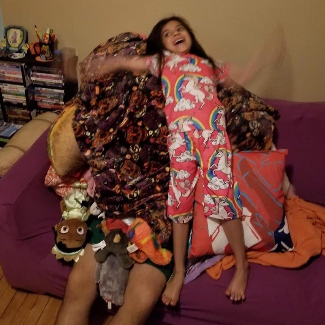 Ellie's stuffed animal tower covering Julio