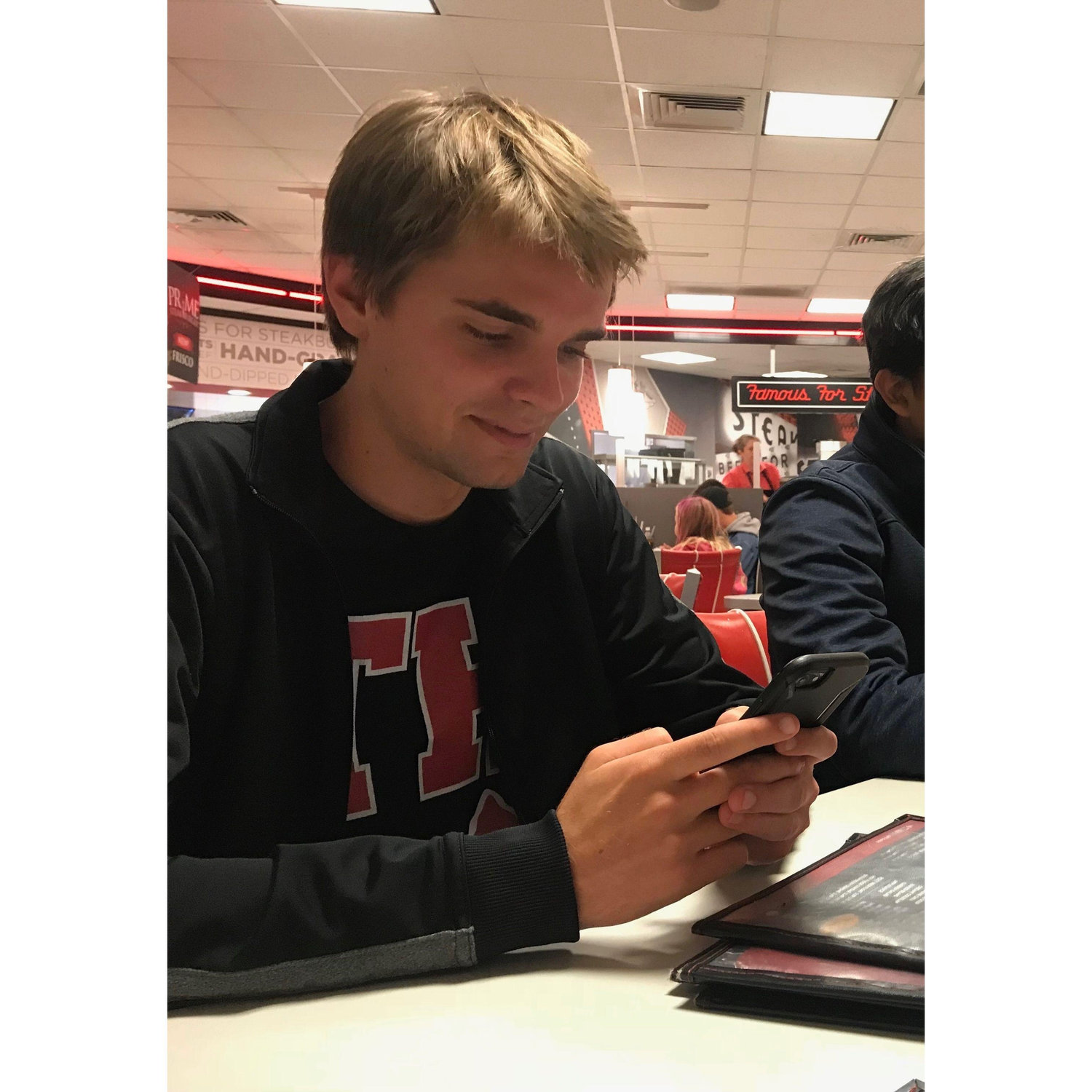 October 26, 2018 - While meeting up with friends, someone caught a photo of him while he was texting me. That smile :) Also, this was taken exactly 7 years before our wedding date!