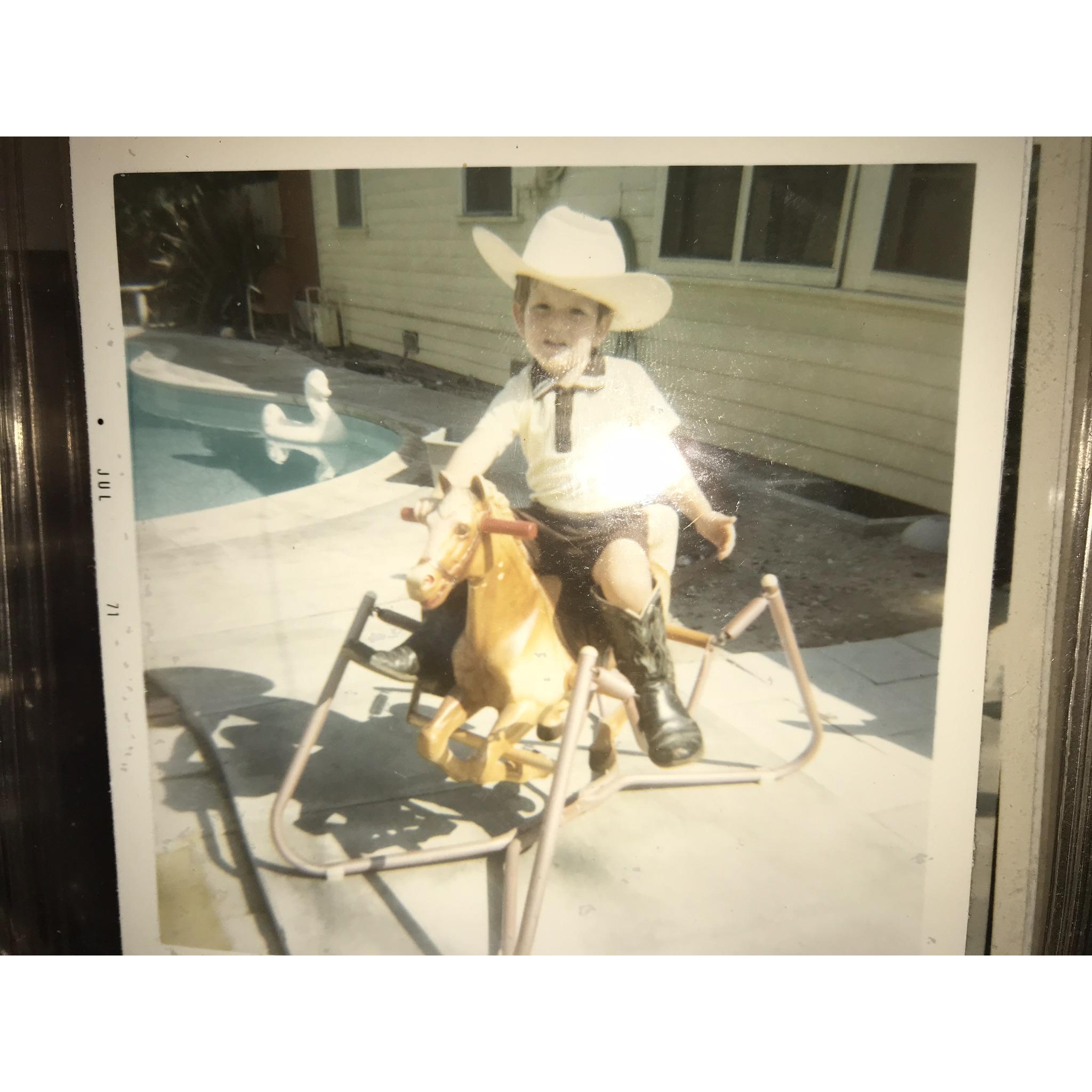 Brian at age 3, riding his horse.