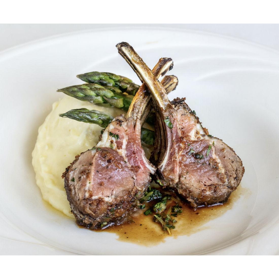 Rack of Lamb: Four Bone Rack of Lamb in a Herb-Mustard Crust served with Garlic Mashed Yukon Potato, Seasonal Vegetable, and Mint Demi Glace.