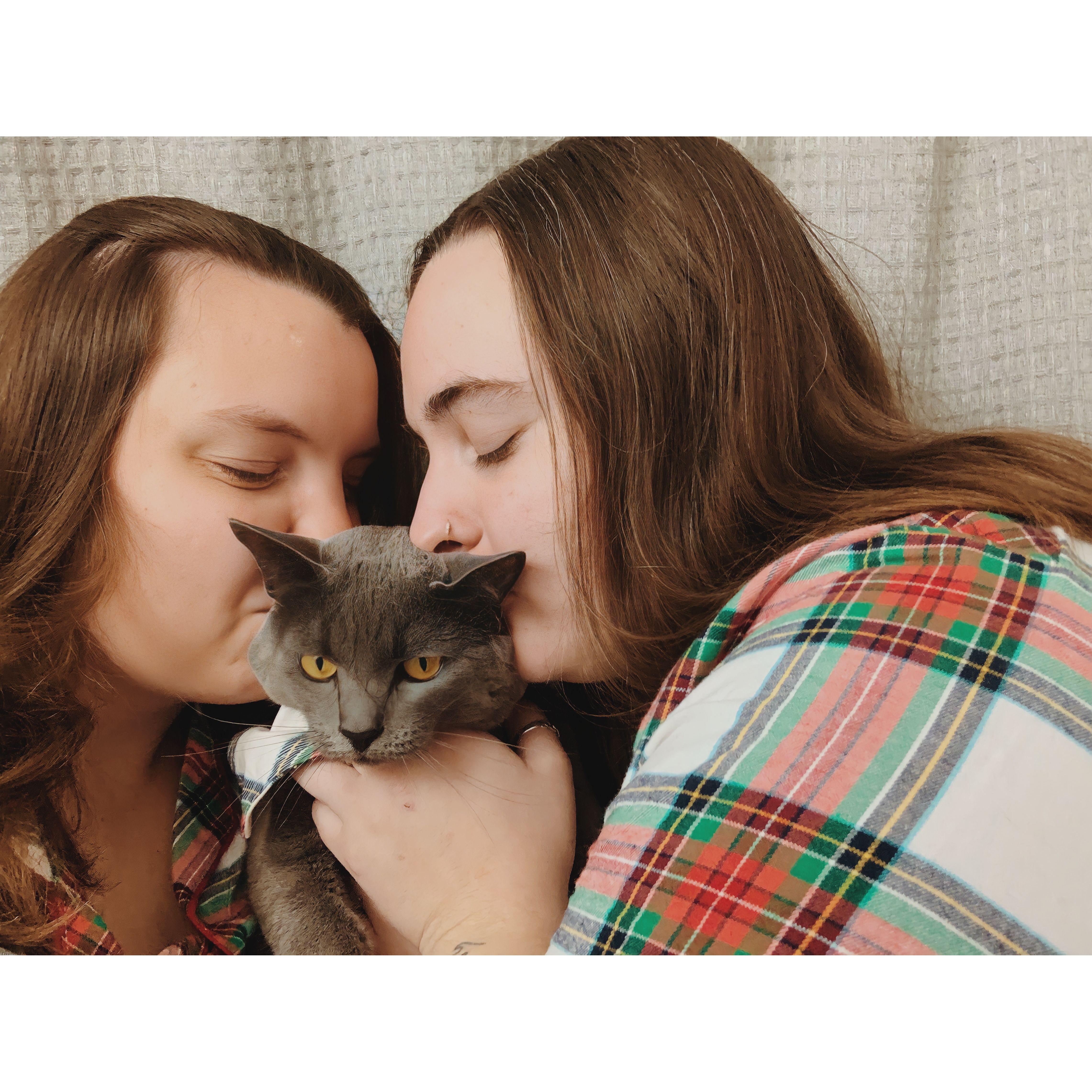 Family photo circa 2022 featuring a very annoyed kitty