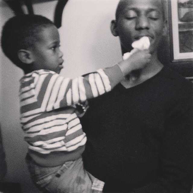 William (Ernest's nephew and godson) helping Ernest wipe cake off his face.