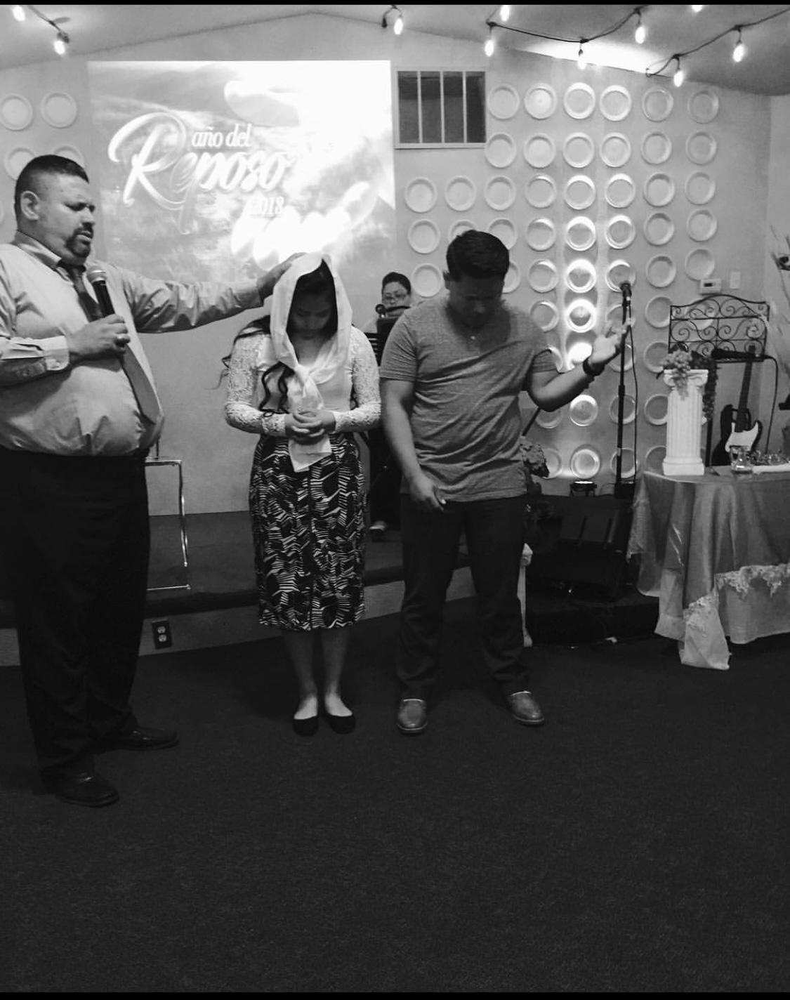 Photo receiving blessing from our Father/Pastor Cesar A Lopez Rivera