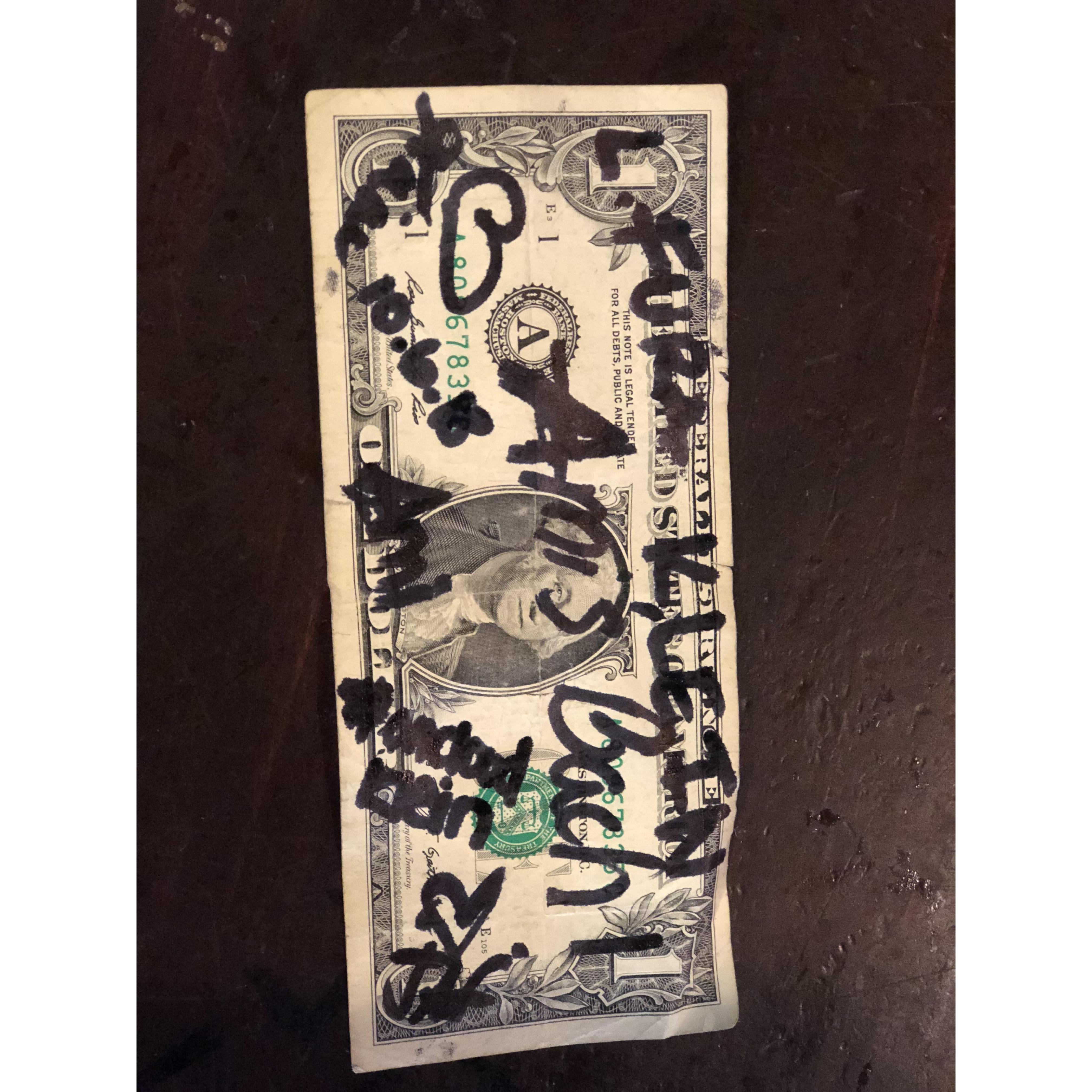 signing dollars at the purple parrot