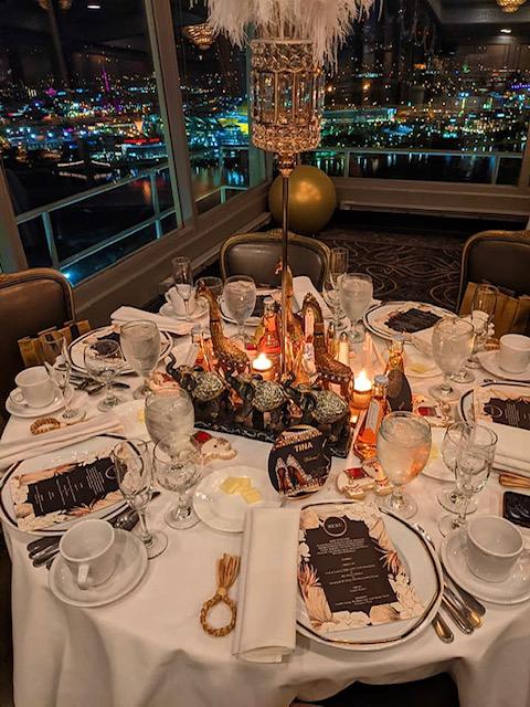 Event and tables designed by Tara | VALLARI Decor™ 28” illuminated ostrich feather centerpiece and Sumind® 36” gold chrome jumbo latex balloons