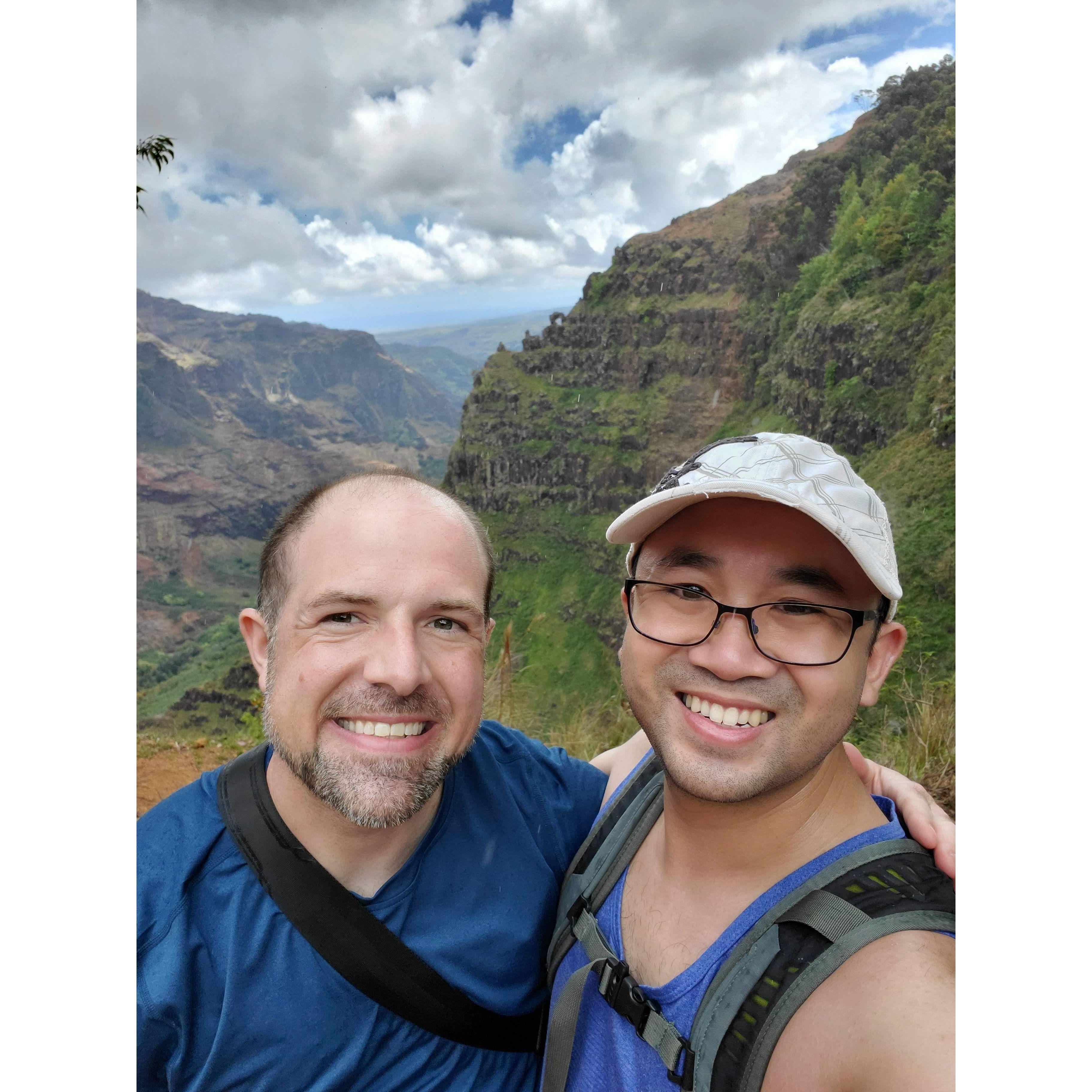 Hiking Kauai to reach the waterfall