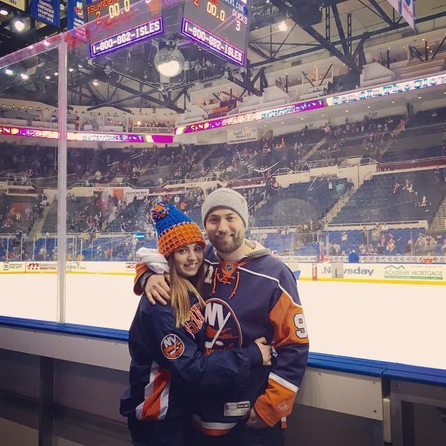 Courtney and Will decked out in matching Islanders gear at an Islanders game in Brooklyn, a Christmas gift to Will from Courtney.