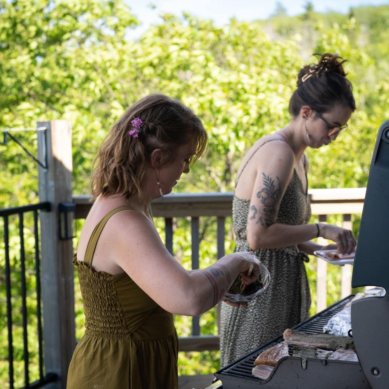 MaryJane & Britt working the grill preparing some local fish.