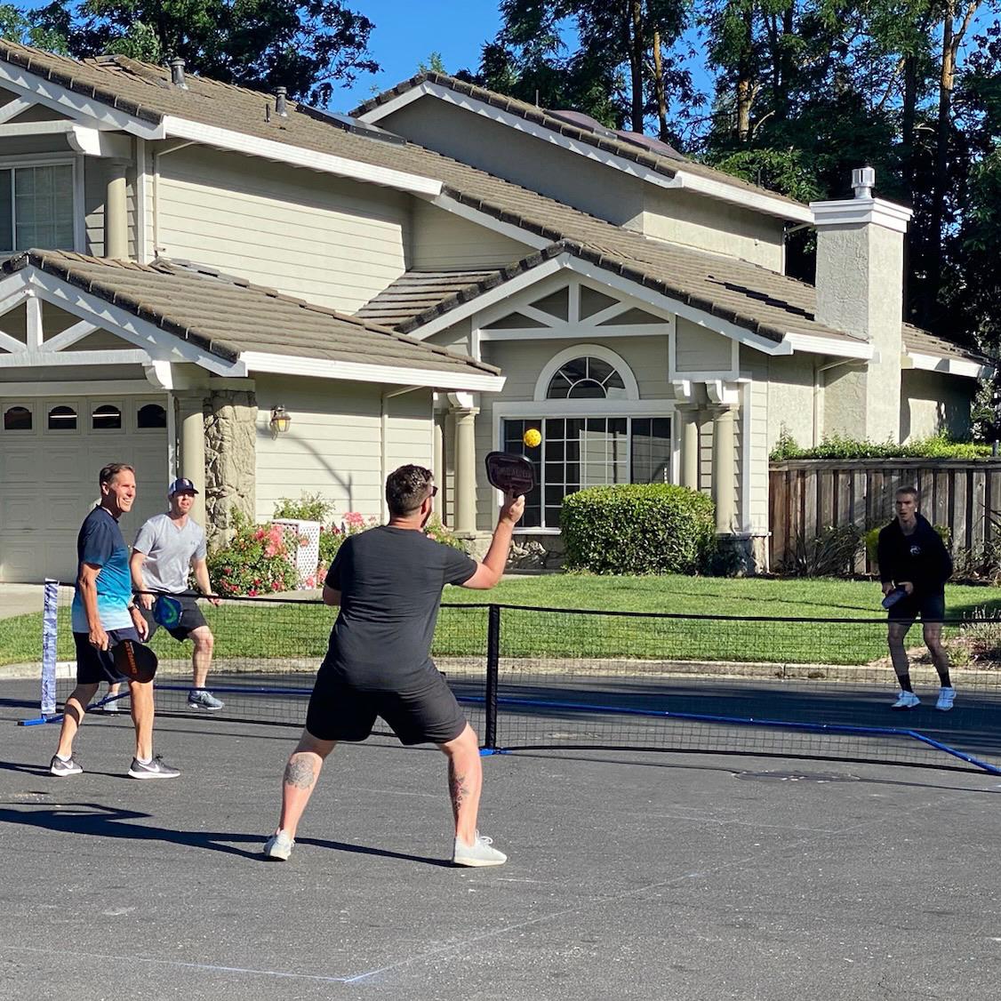 The Platon boys playing pickleball in the cul-de-sac.