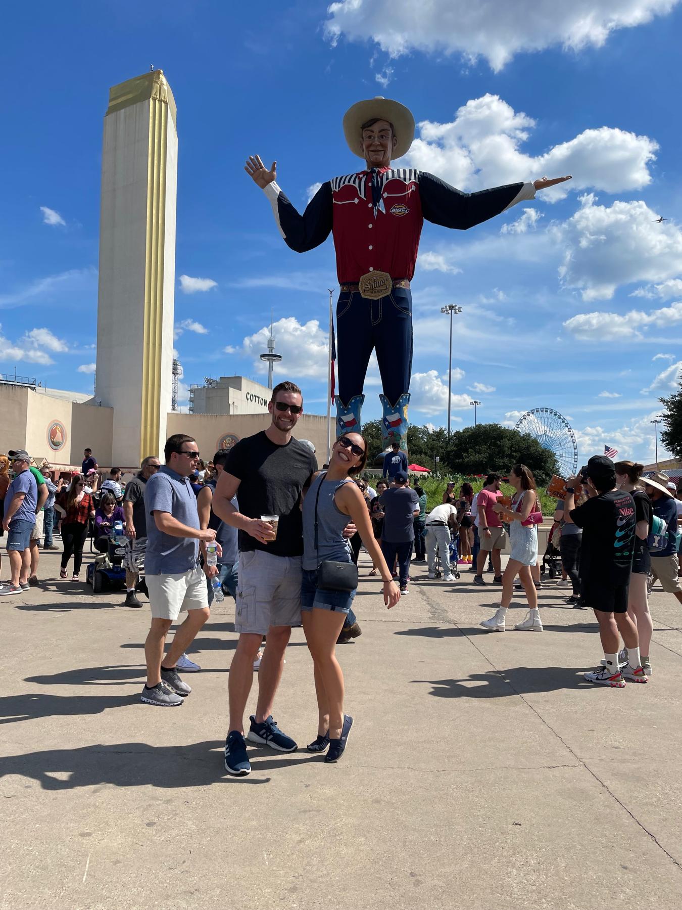 Texas State Fair! And Nicole trying to measure up to Big Tex on her toes