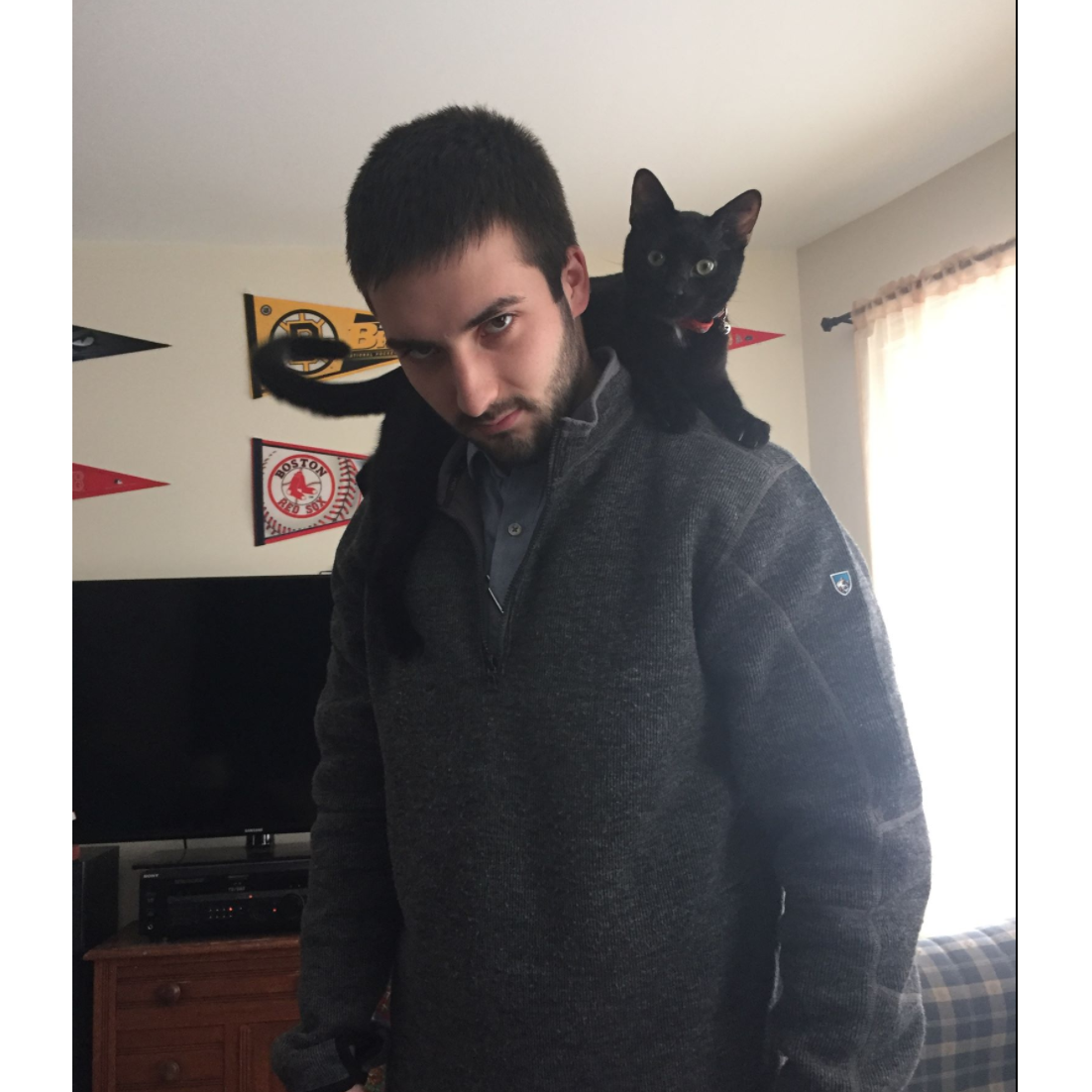 Cameron with a young Kilo hanging out across his shoulders in the fall of 2015. Still a preferred kitten spot for Kilo to jump to today at the age of 3.