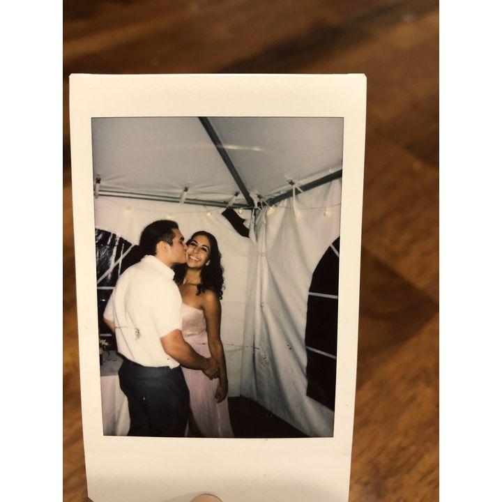 Snapping a polaroid at a wedding in 2018 (before we snuck out to swim in the lake!)