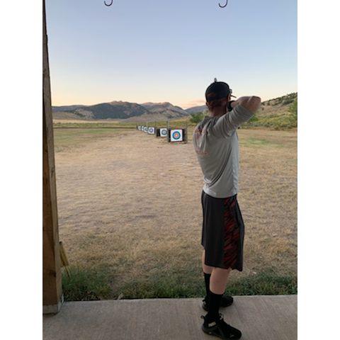 Matt teaching Anne to shoot archery!