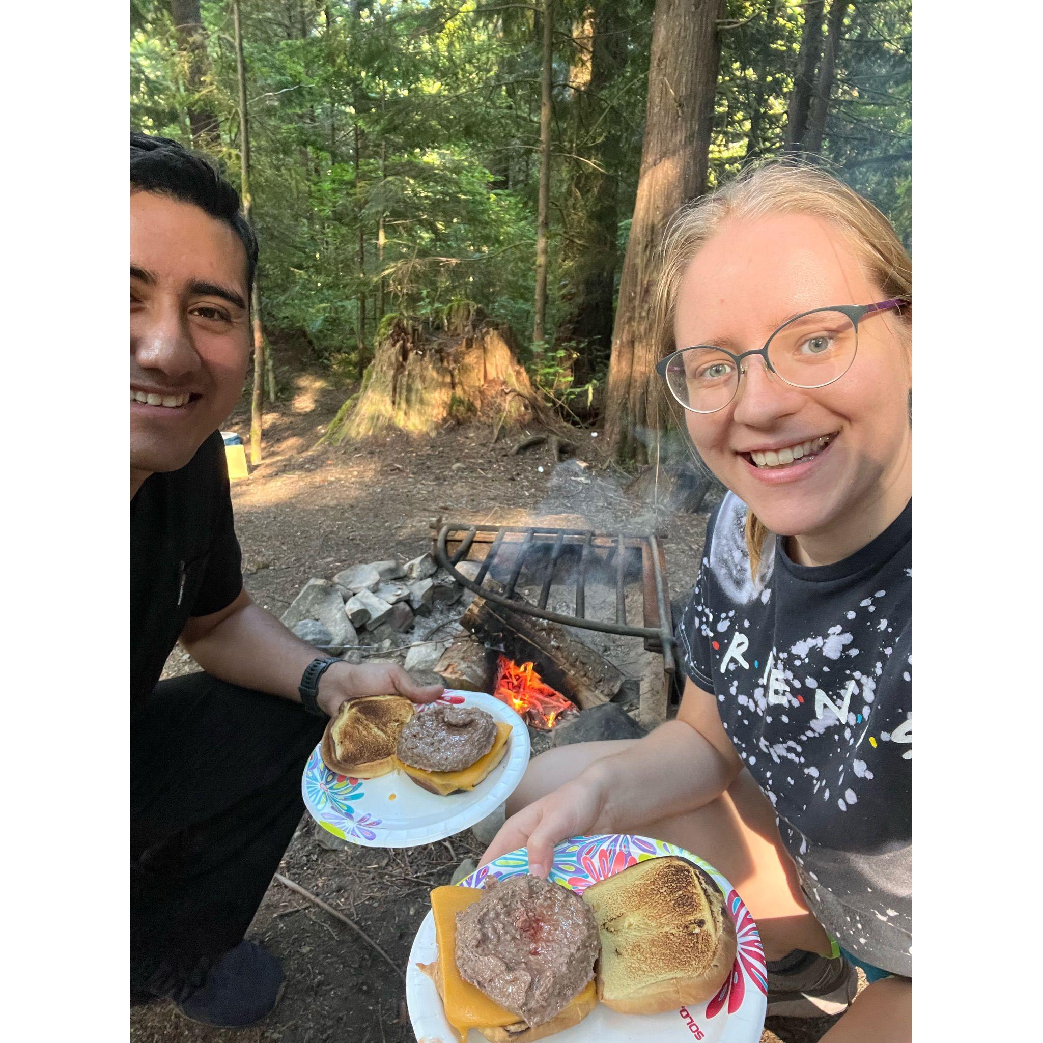 Hamburgers cooked on a fire while camping