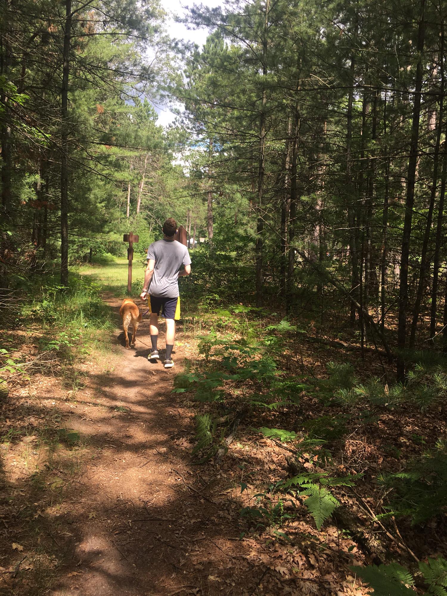 Trevor and Mazie hiking through Tawas.