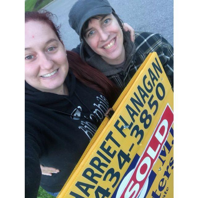 Us in front of the Sold Sign for our New House!