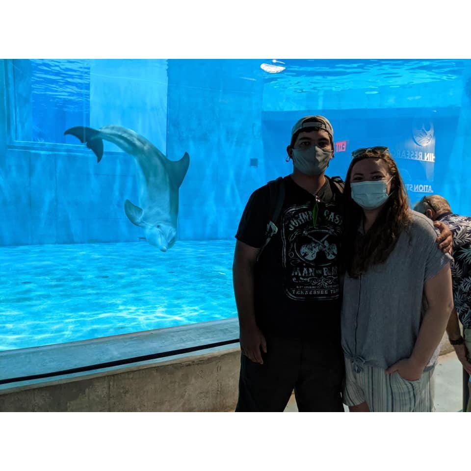 Posing with their dolphin friend at the Clearwater aquarium in Florida.