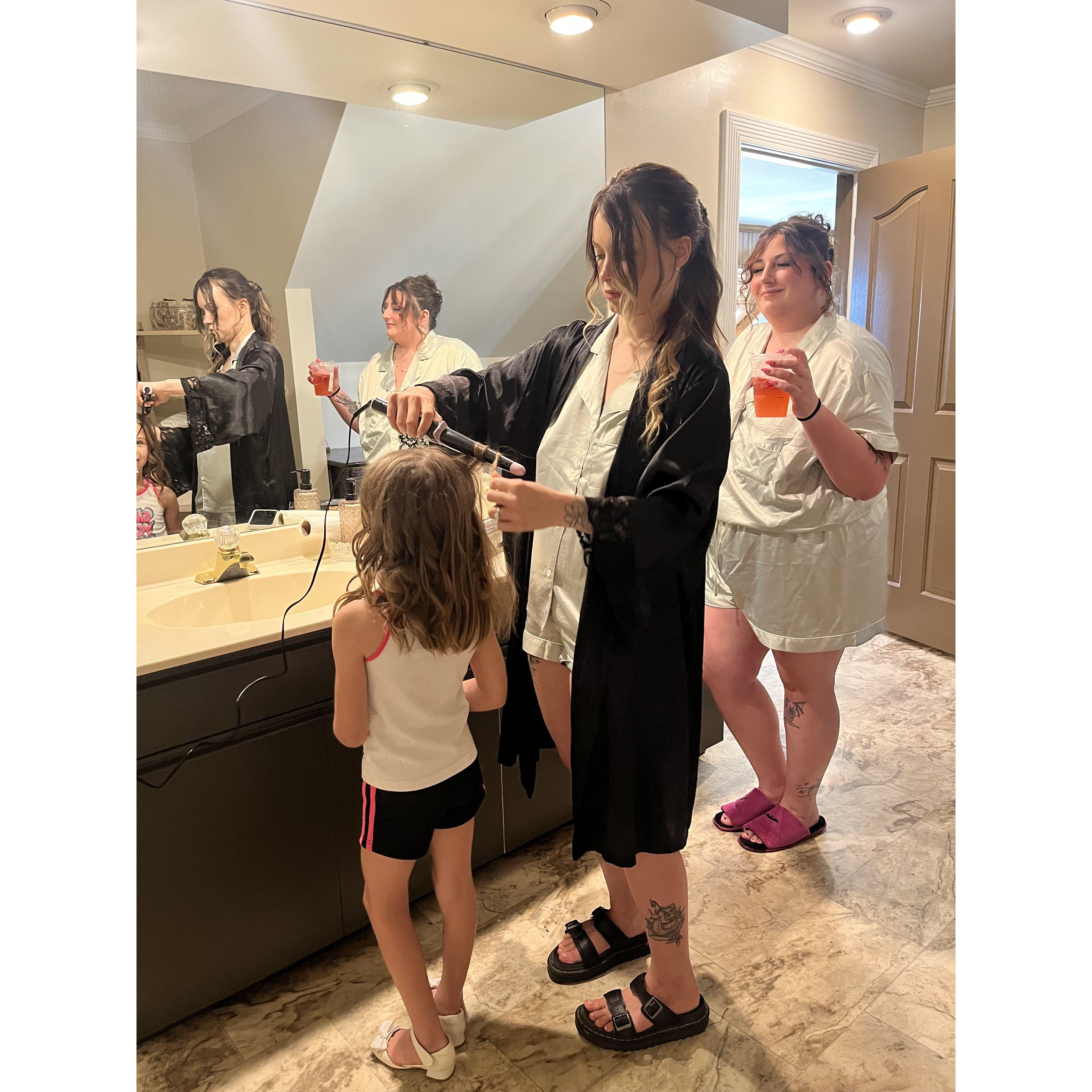 Shian doing Elliana, Sarai's niece's hair, and Adi