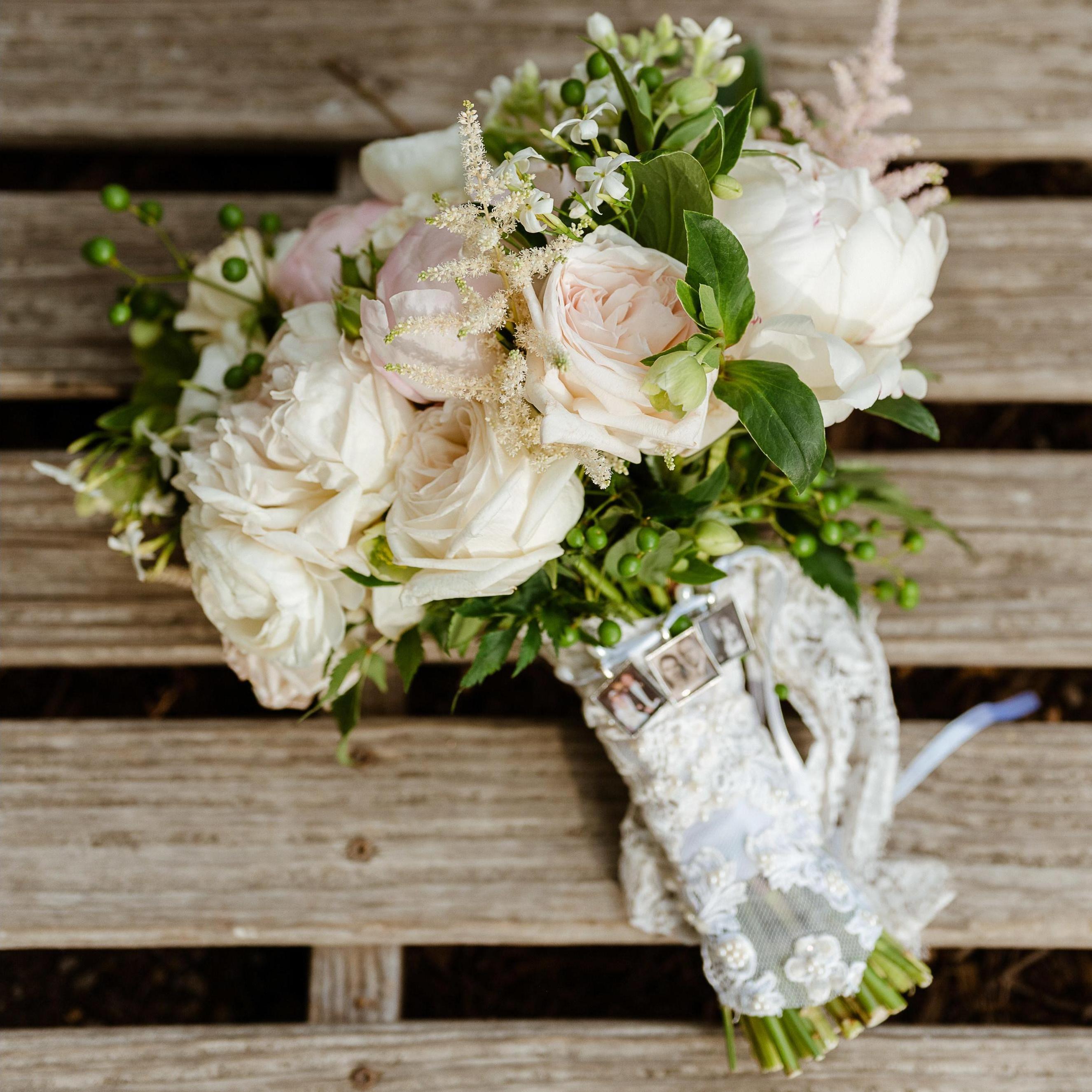 Lauren's bouquet - lace from her paternal grandmother's wedding dress, lace from her mother's wedding day, and photo charms from her parent's, grandparents' and great-grandparent's weddings