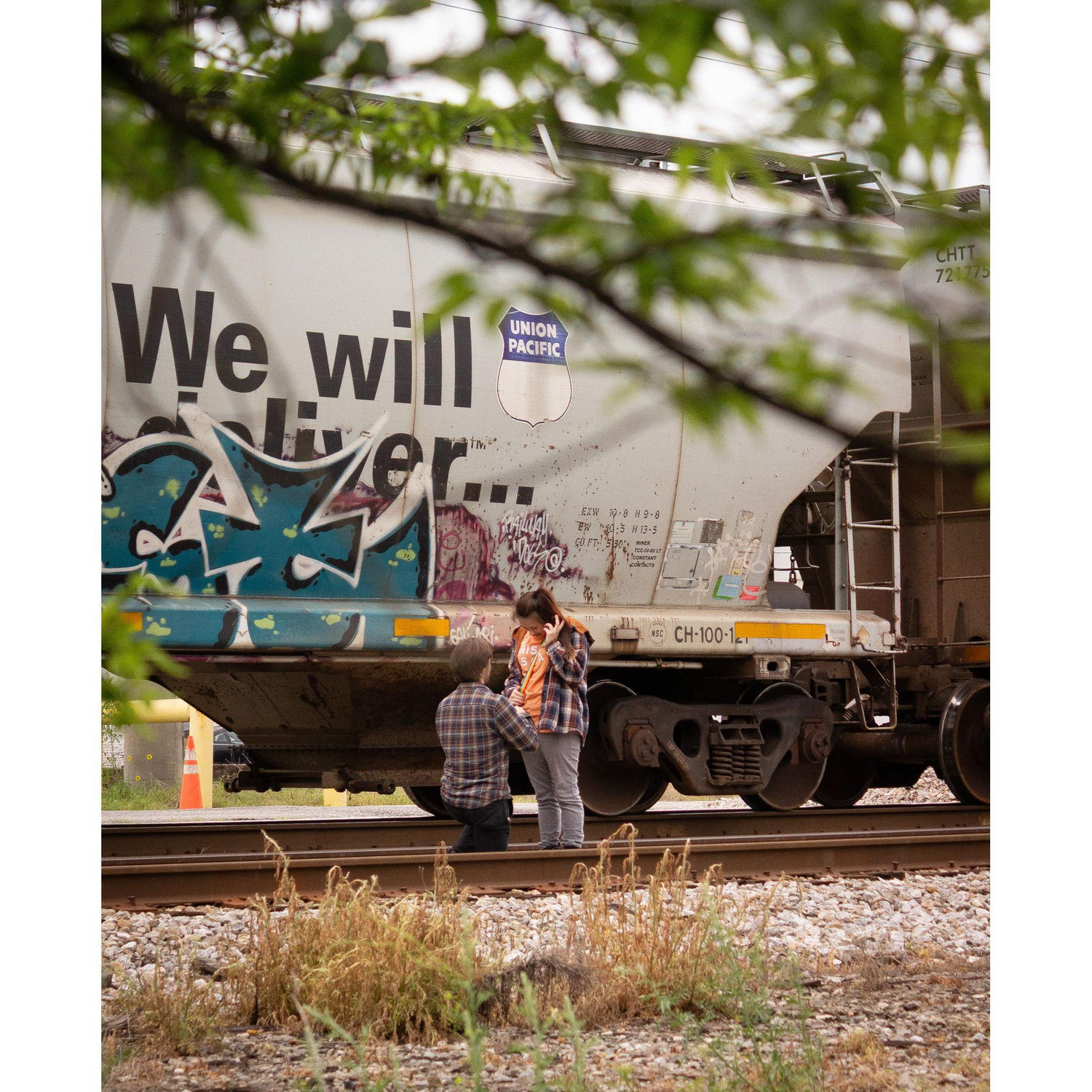 Zach proposing by the train tracks