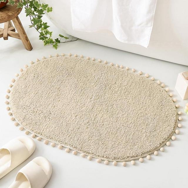 YIRDDEO Oval Bathroom Rugs Beige Rug with Pom Cream Bath Mat for Bedroom Non Slip Cute Boho Absorbent Mats Soft Plush Washable Rug (20x30 inches)