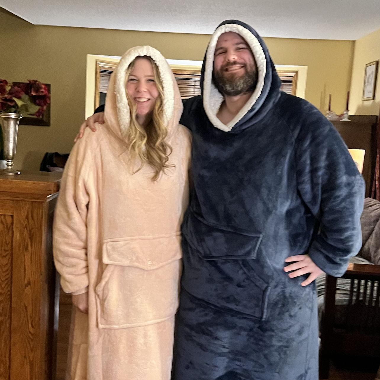 Giant wearable blankets, looking ridiculous, and loving every second of it — together.