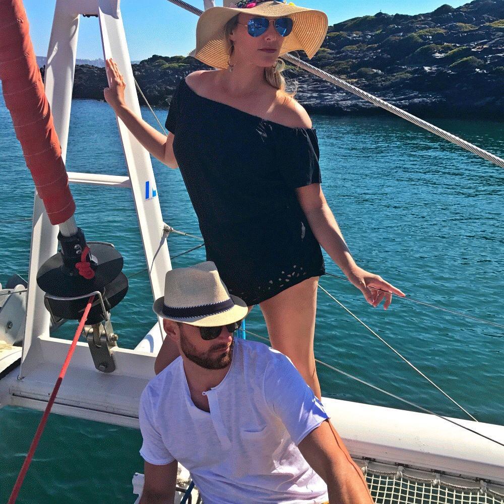 Pretending to be supermodels in a perfume add on a Catamaran in Santorini.