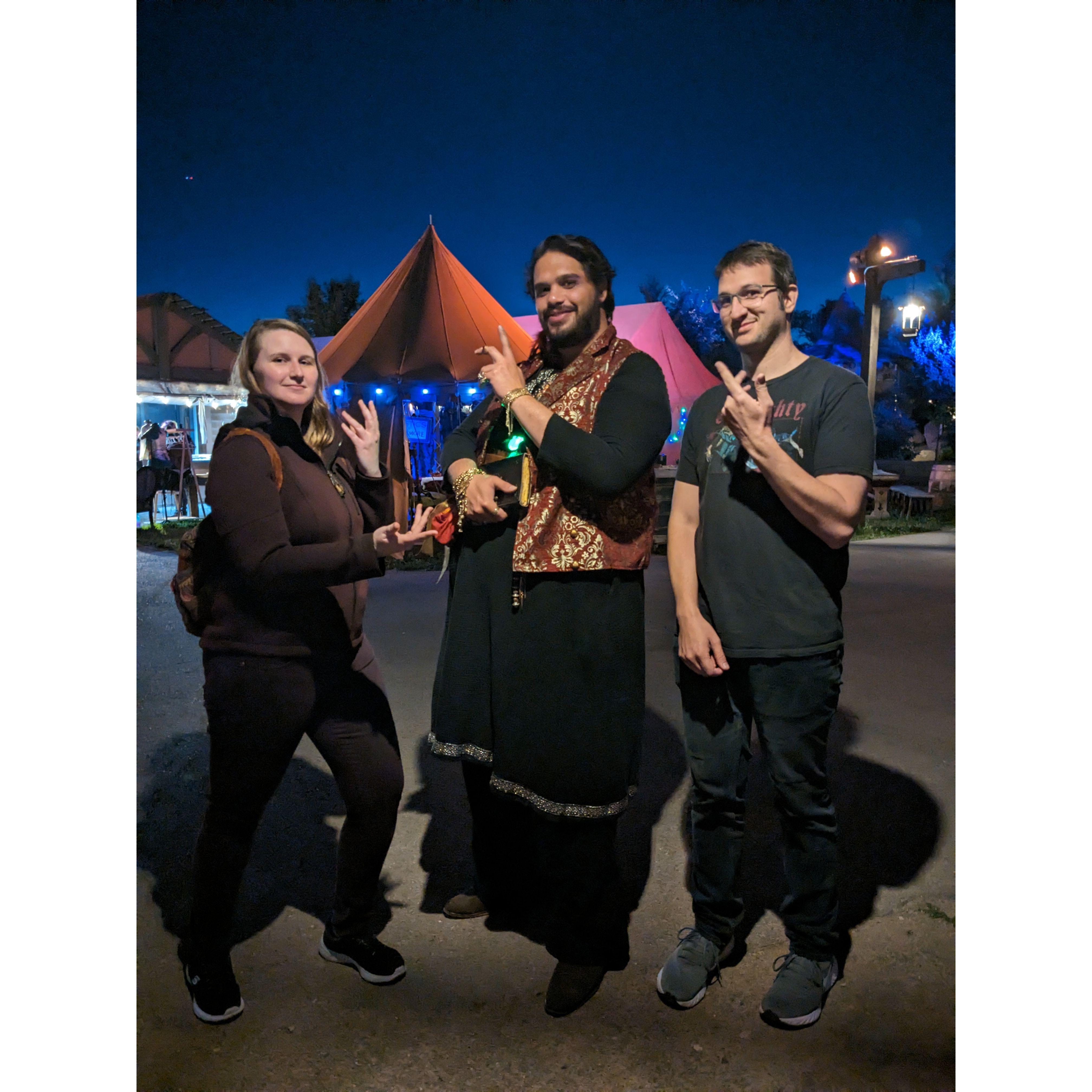 The couple posing with a local sorcerer in Evermore.