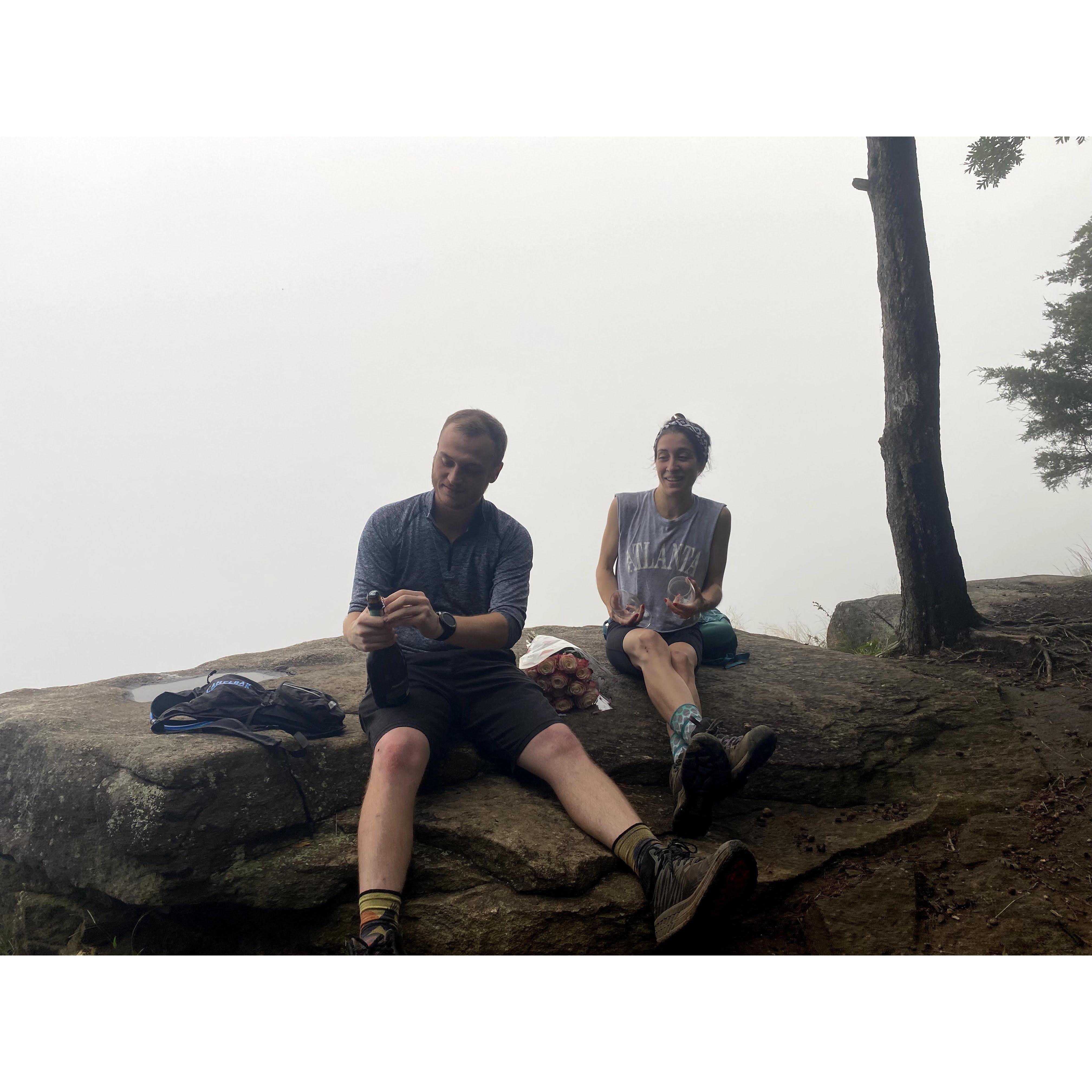 Poppin Champagne on Mt Yonah. Tyler's buddy, Julian, hiked up with the bottle, two glasses and flowers! And photographed the proposal!
