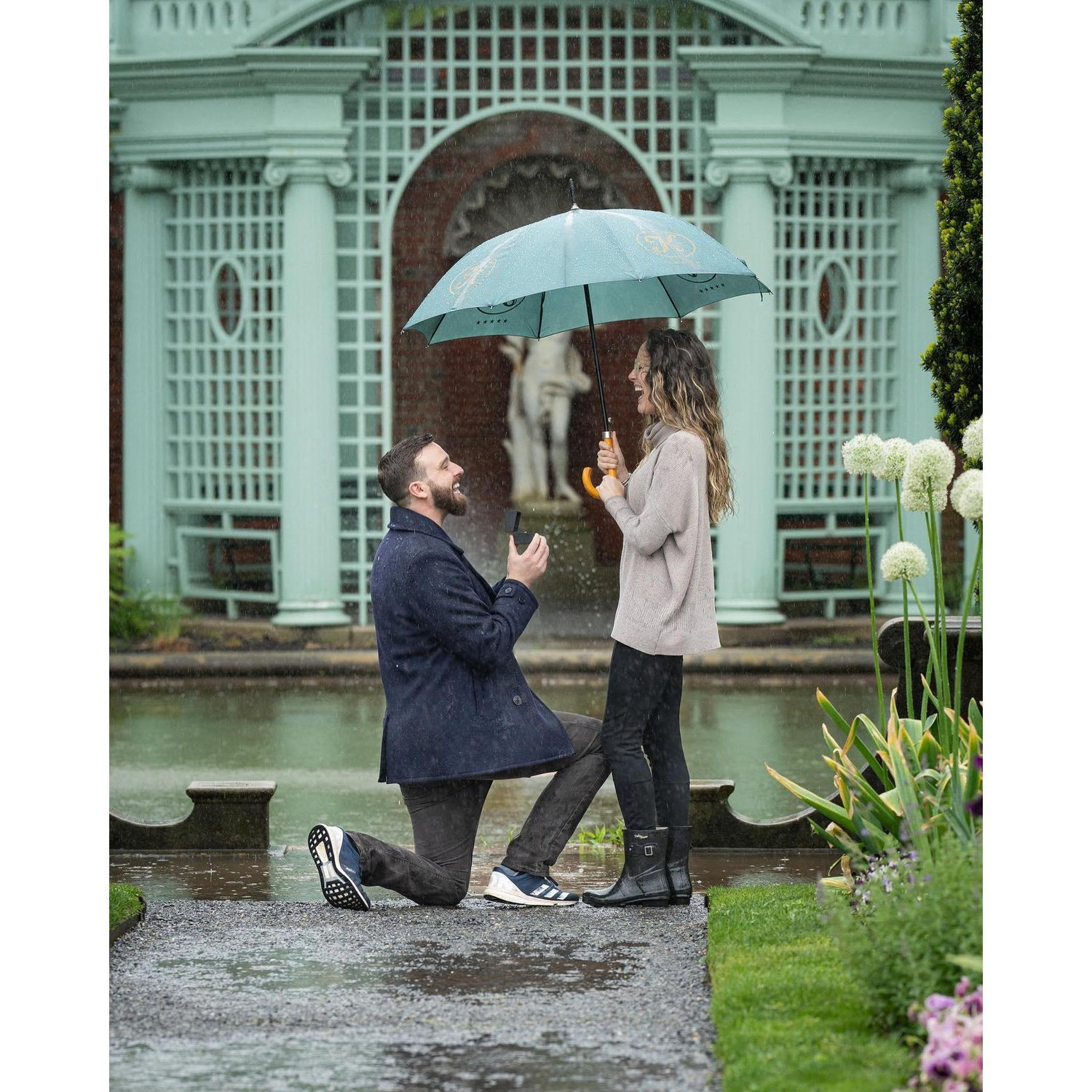 Rain or shine, Dean planned the perfect proposal. Despite Catt's stopping every few feet to identify and announce each flower variety, Dean pushed on, found the perfect puddle, and proposed!