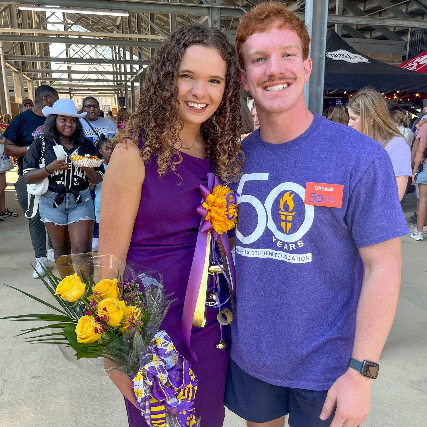 Georgia's mom made both of them awkwardly take a photo together at Ouachita's Homecoming game. This was right after Georgia's brothers called Caleb over and introduced themselves.