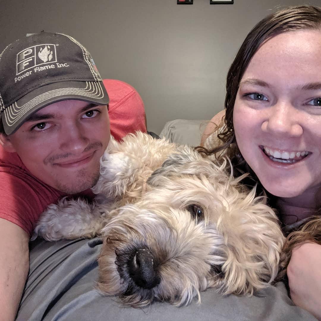Tom and Tori pose with their newly adopted dog, Olly, in 2019.