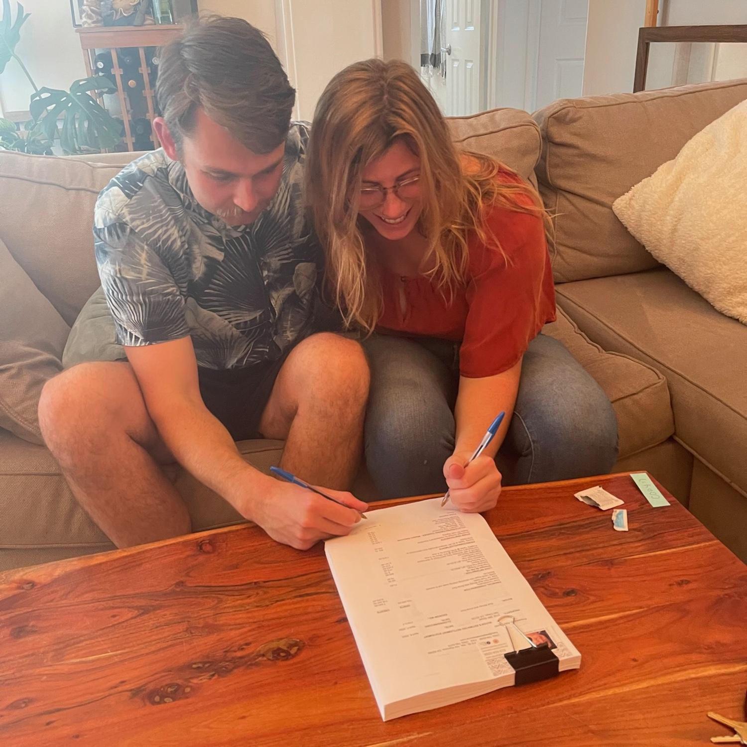 Signing the docs to buy our first house in 2022!