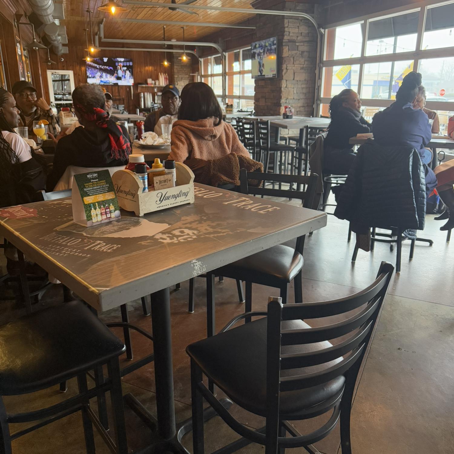 The exact table they sat at on their first date. (There was trivia going on and they could barely hear each other!)