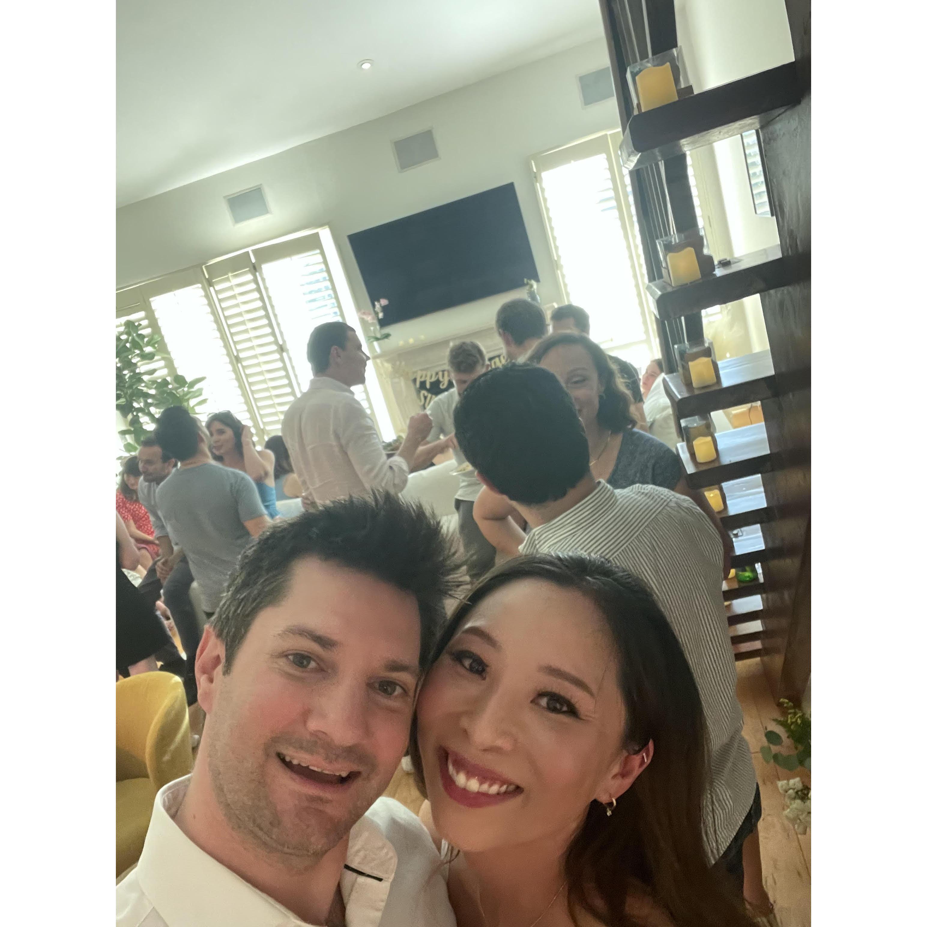 Celebrating our engagement at home in June 2024.