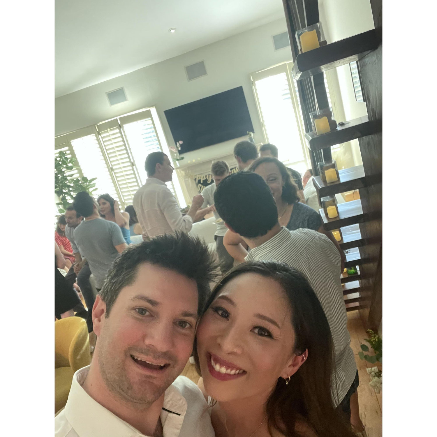Celebrating our engagement at home in June 2024.