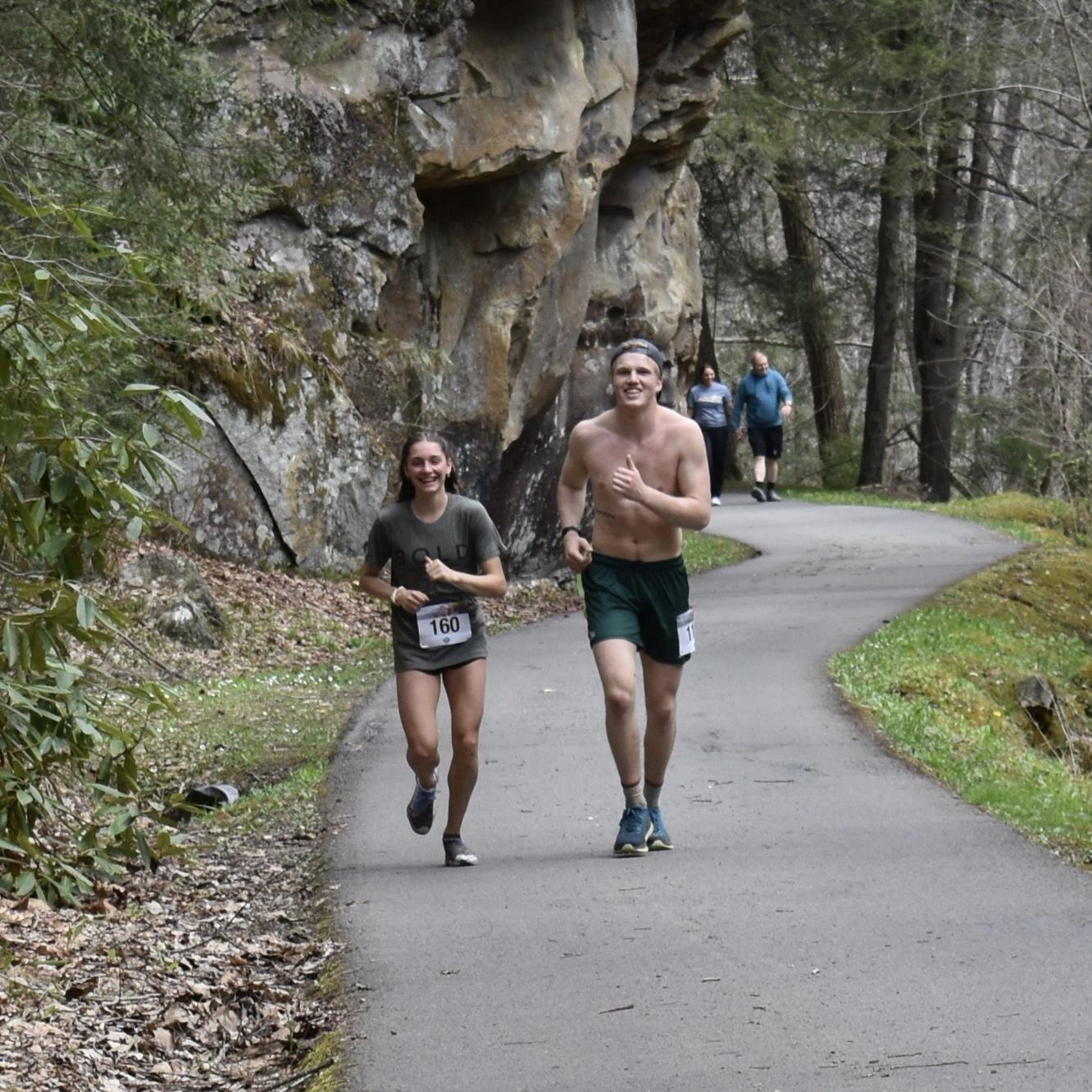 Running together (Parker dragging Maddie) at the Babcock Gristmill Grinder Half Marathon, April 2022