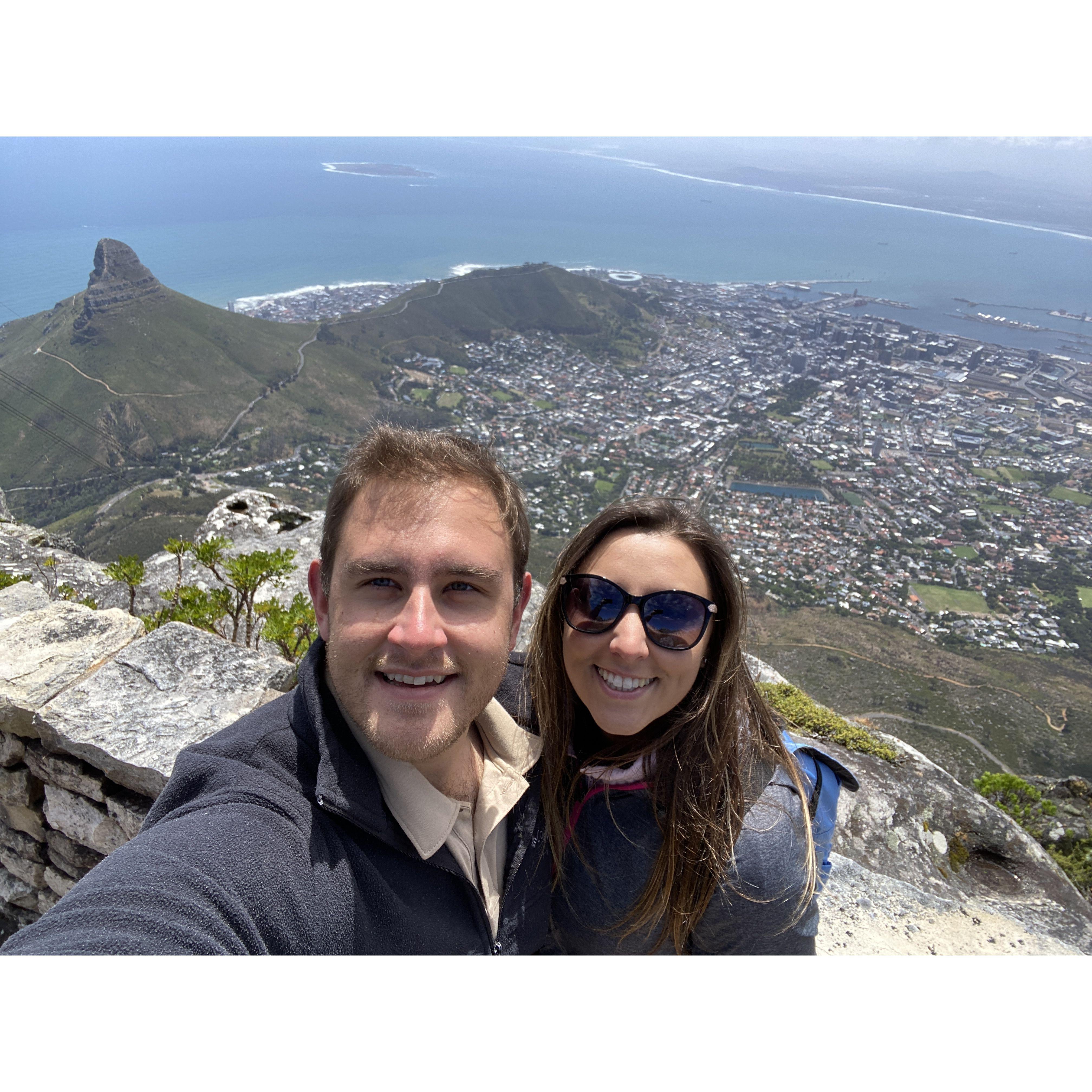 The couple made it to the top of Table Mountain in Cape Town, South Africa! They were lucky enough for the clouds to clear so they could see for miles and miles - a rare sight for most SA travelers!
