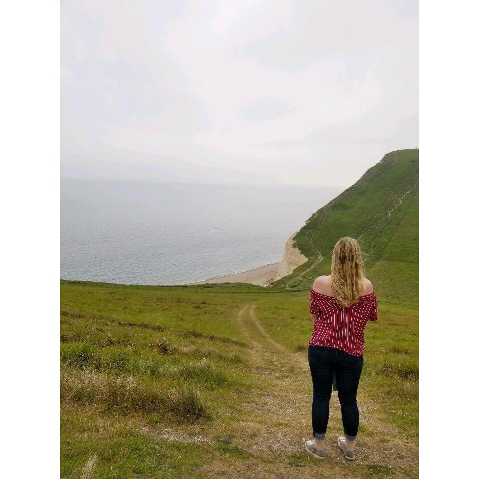Admiring the vast landscape at Durdle Door.