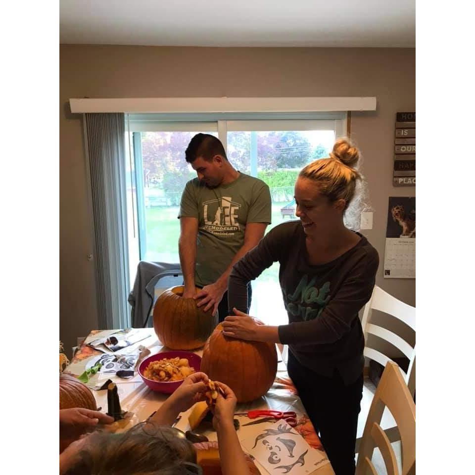 Carving pumpkins with Madison's parents and sisters.
