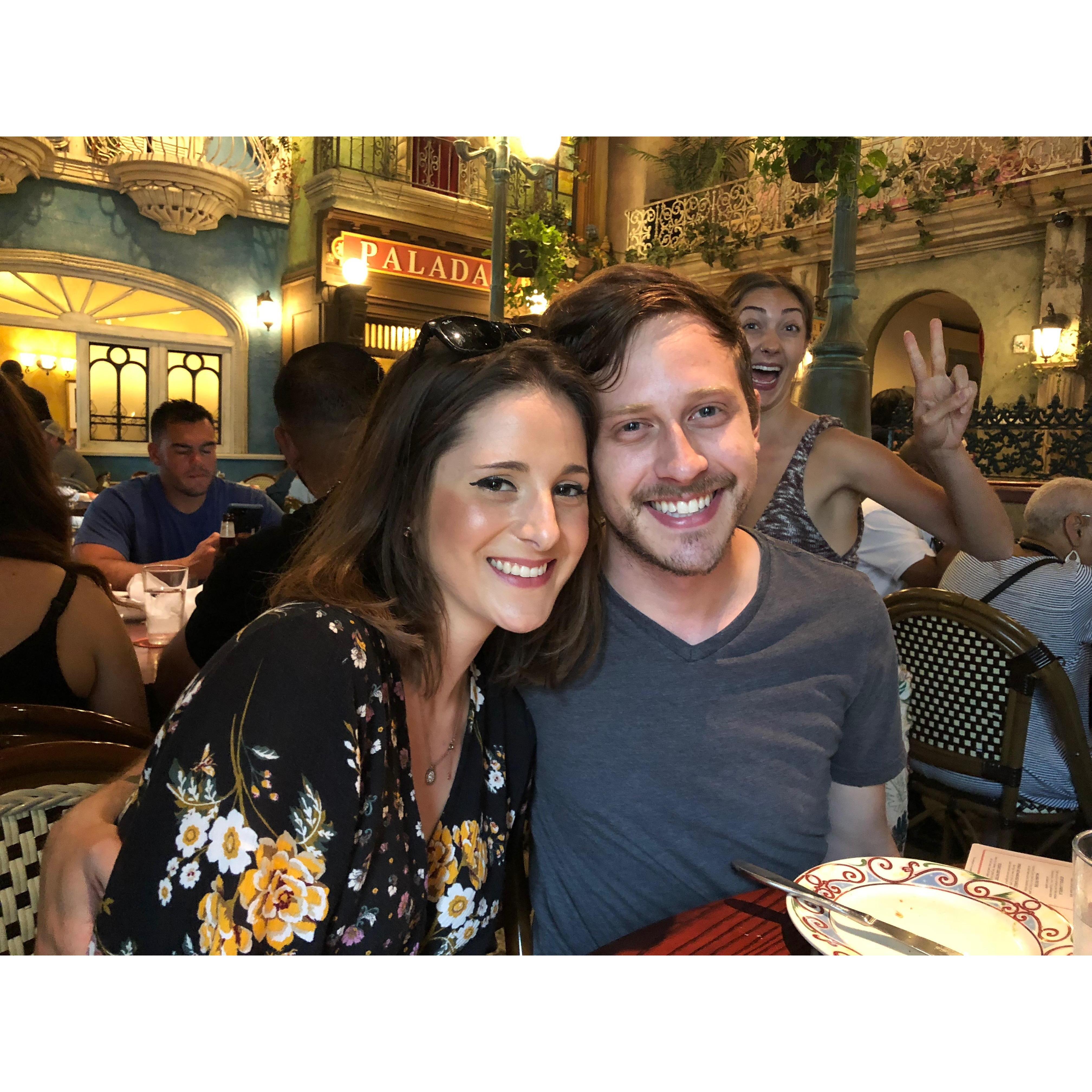 Brunch at Cuba Libre. Juliana flashes a peace sign on her way to the restroom. A man looks on his phone in the background.