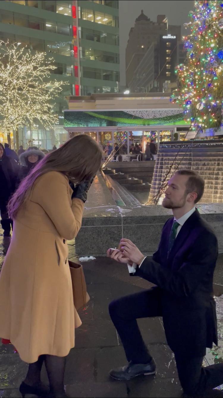 The proposal in front of a huge Christmas tree in Downtown Detroit.
