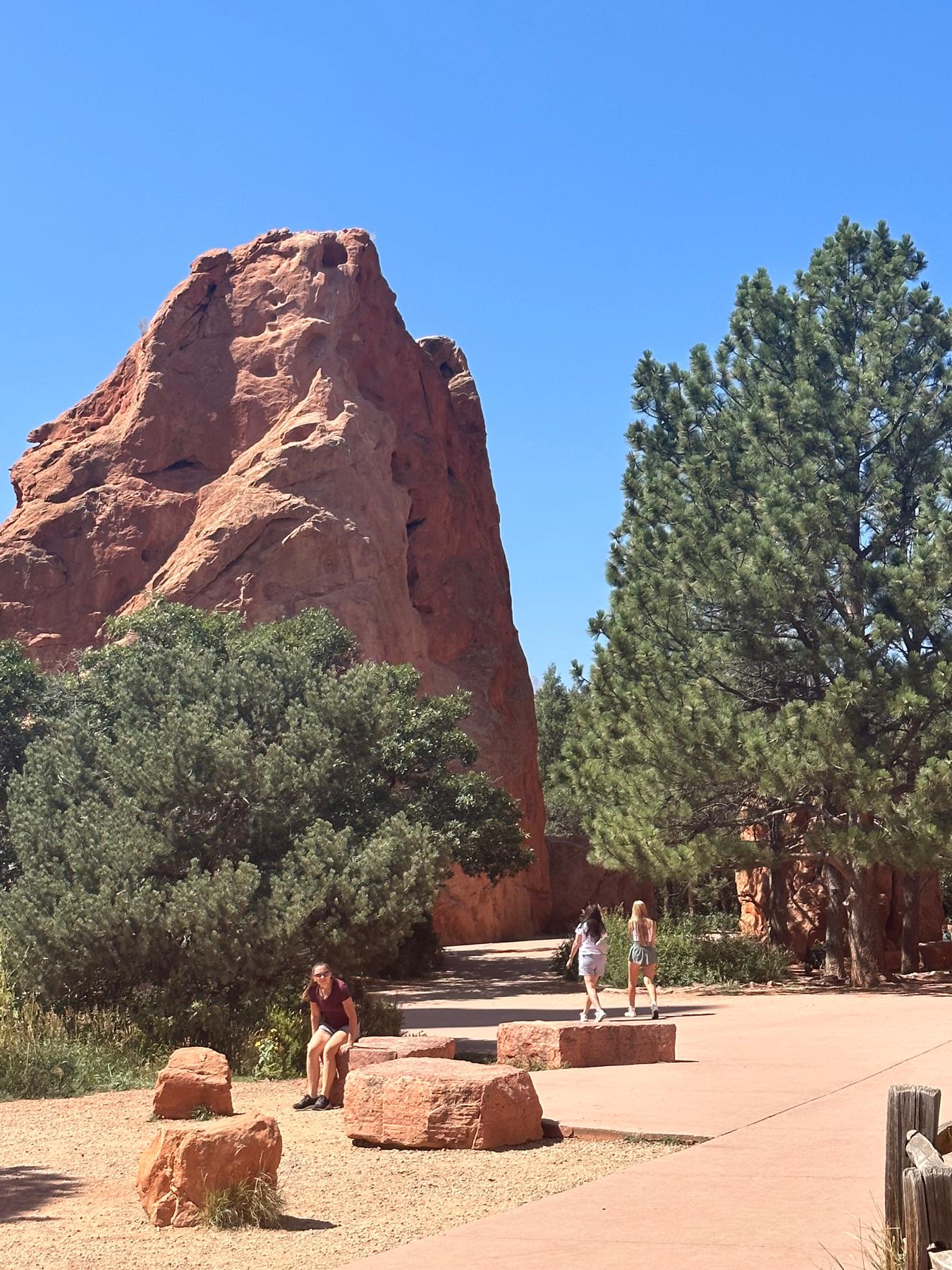 The view of the back of the rock that you will see while walking up to the ceremony location. Dads please stand here.